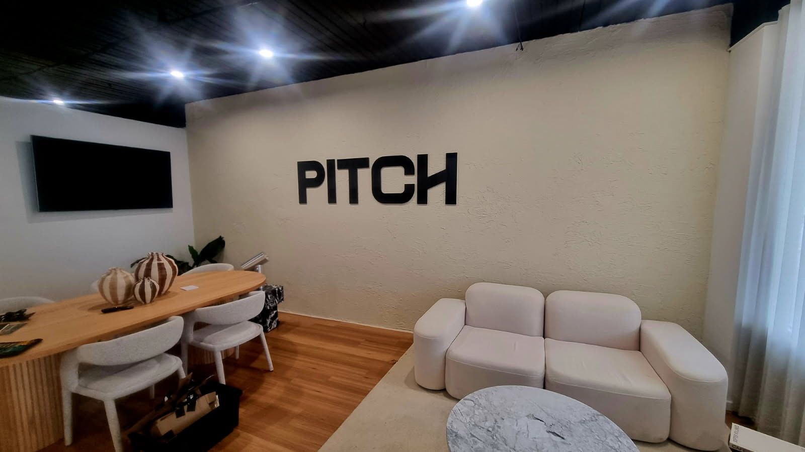 Black acrylic Pitch lettering on a meeting room wall