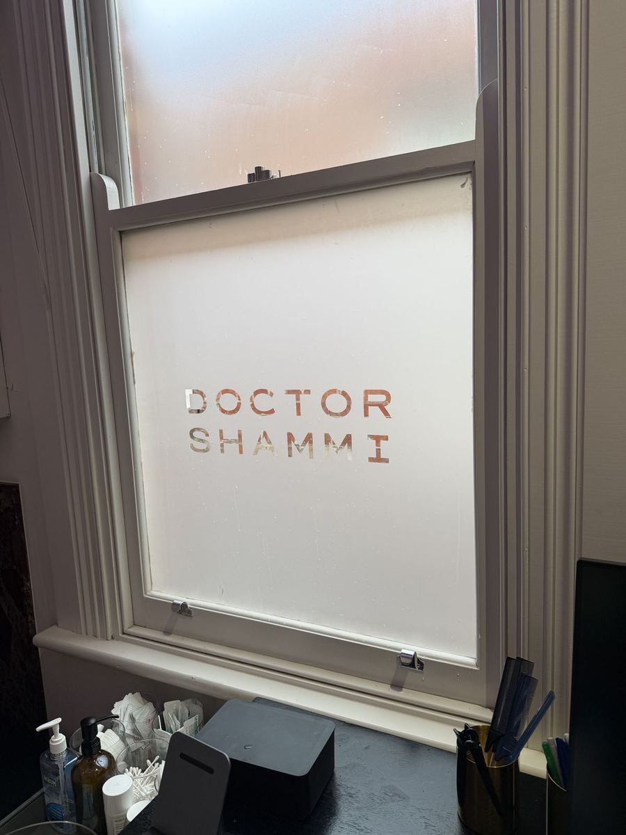 Frosted window film with a cut-out Doctor Shammi logo