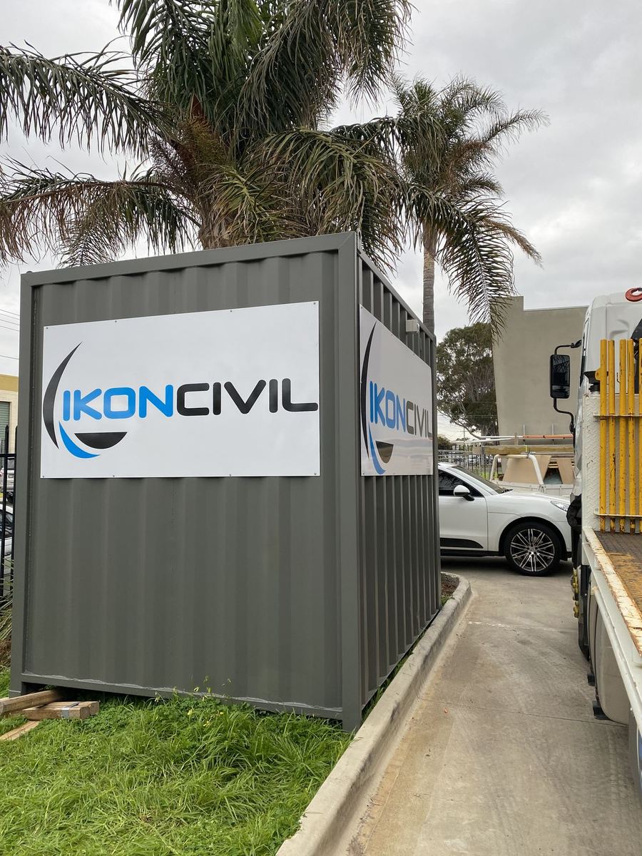 ACM panel logo signs fixed to a site container at a civil contractor's yard