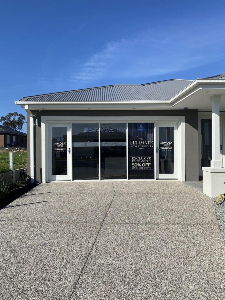 Mimosa Homes display home frontage with window signage