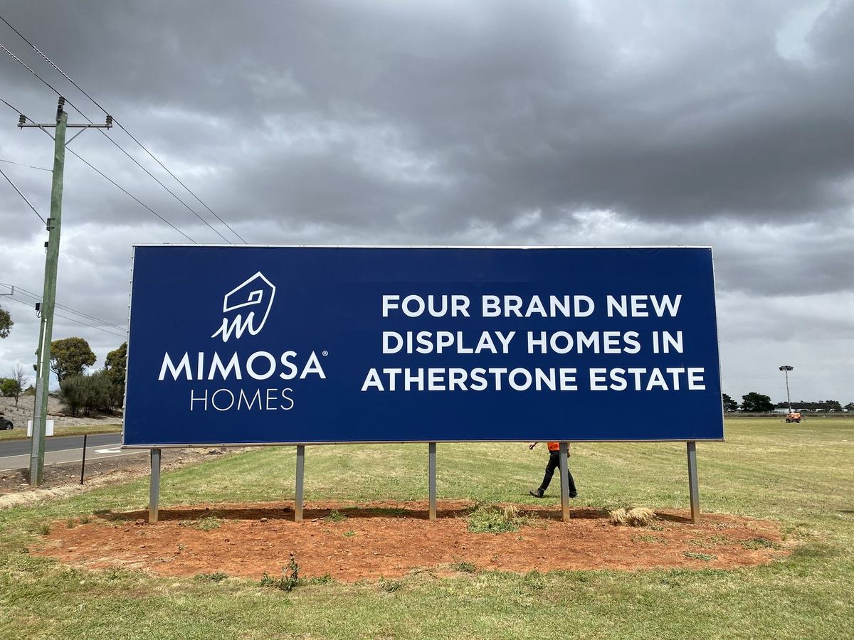 Large Mimosa Homes billboard announcing four new display homes