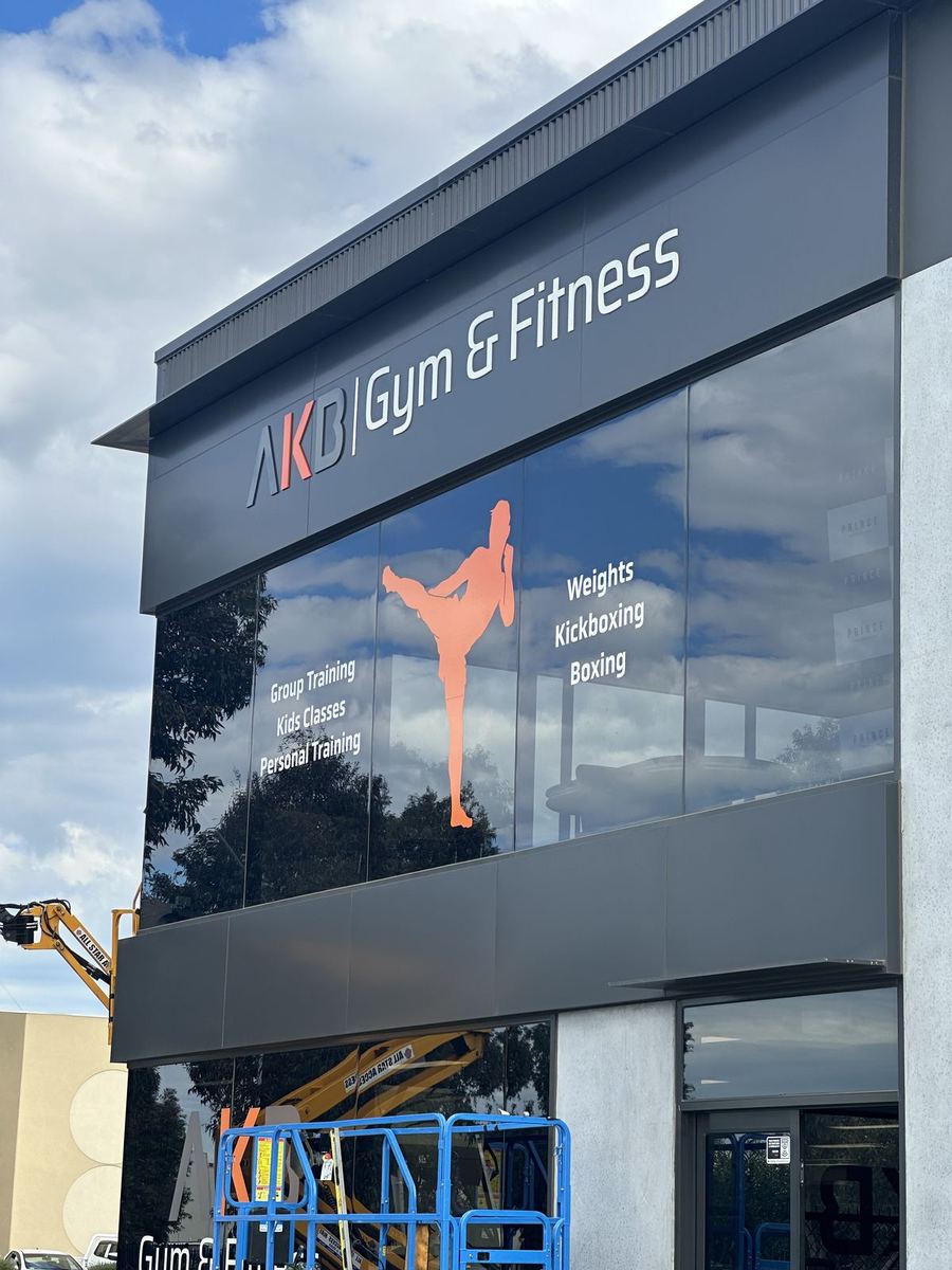 Fascia letters and kickboxer window graphic on a two-storey gym facade