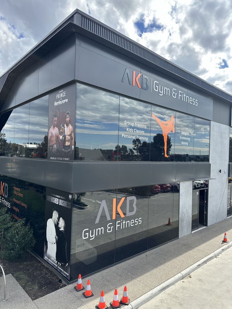 AKB Gym & Fitness dimensional letters on a grey fascia above printed window graphics