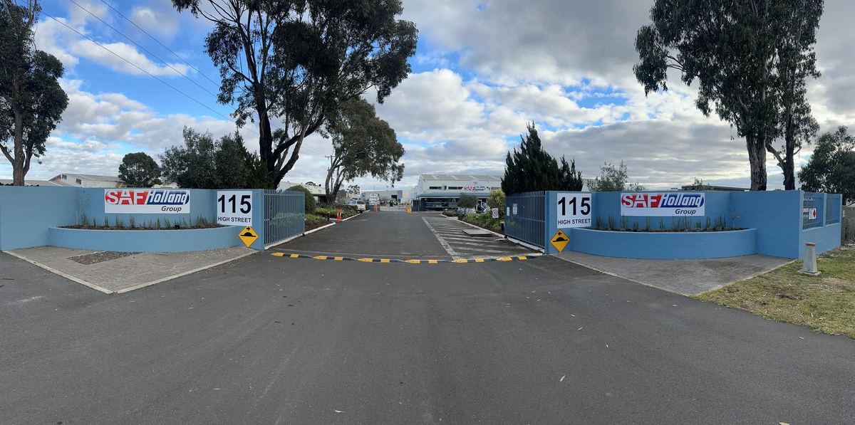 SAF-Holland entrance wall signs and street number panels at an industrial site gate