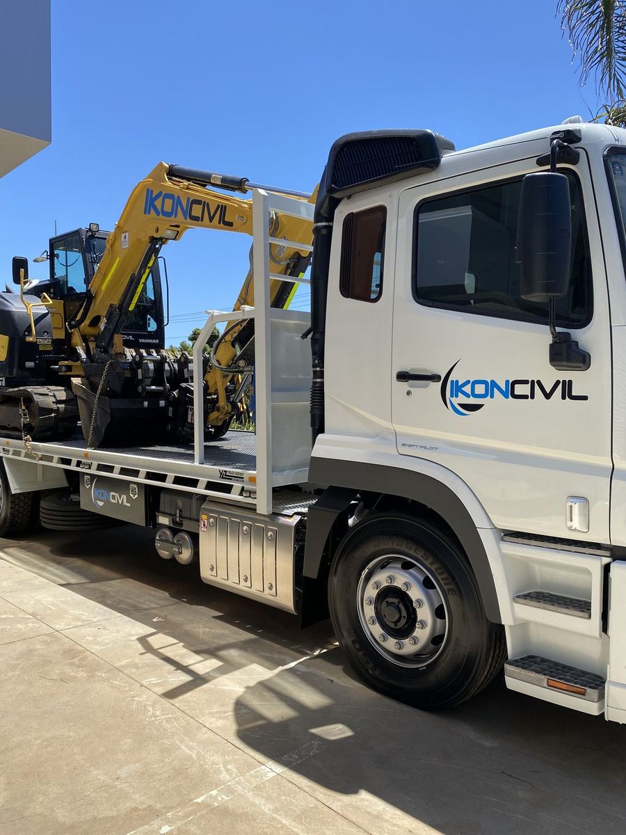 Ikon Civil truck with door logos carrying a digger