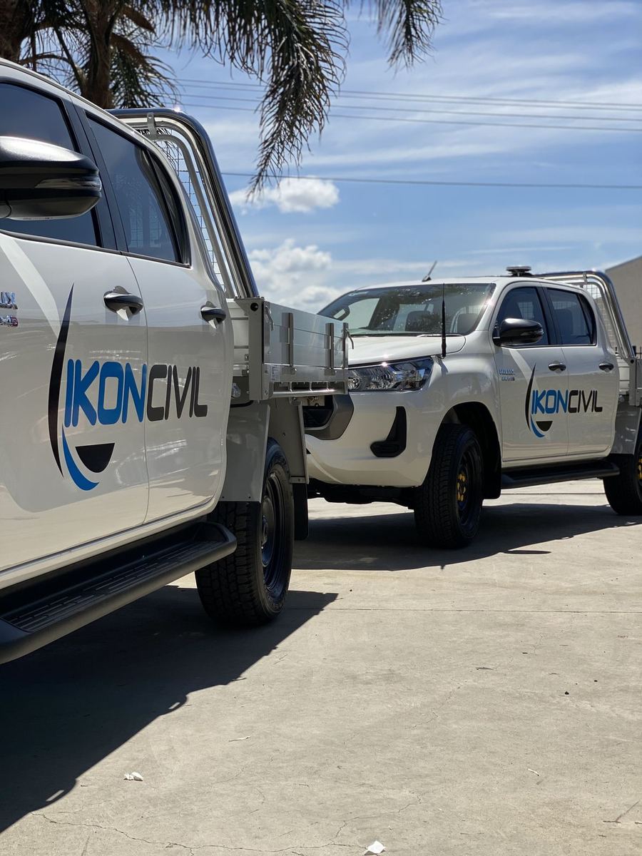 Two Ikon Civil utes with door logos