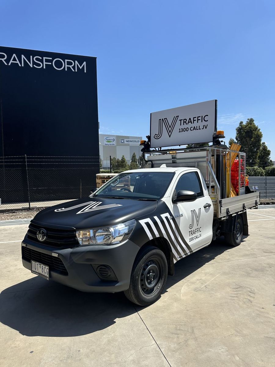 Partial wrap with black bonnet and striped front guard on a JV Traffic Toyota HiLux tray ute